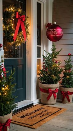 two christmas trees are on the front porch