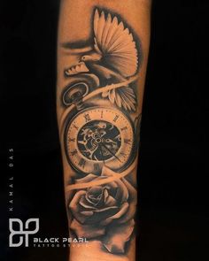 a black and white photo of a clock with roses on the arm that has a bird flying over it