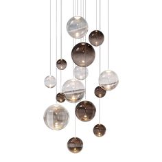 a group of glass balls hanging from a ceiling fixture with lights on each one side