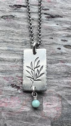 A tiny genuine birthstone has been wrapped in sterling silver. The natural gemstone dangles from a small silver rectangular pendant. I have cut the rectangle from a sheet of solid sterling silver. I then stamped a branch into the center of the pendant and lightly hammered the border. The pendant hangs from a sterling silver chain which features a lobster claw clasp and a 3-inch extender allowing the chain to be slightly adjustable.Be sure to see all photos and video for size and color reference. Sterling Silver Birthstone Necklace, Color Reference, Patina Finish, Personalized Birthday Gifts, Pink Opal, Birthstone Necklace, Chain Ring, Silver Jewellery, Lobster Claw