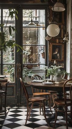 an old fashioned dining room with black and white checkered flooring, potted plants on the table