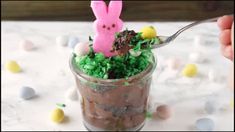 a cup filled with chocolate pudding and topped with an easter bunny