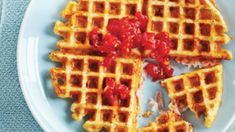 waffles with ketchup and mustard on a white plate