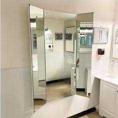 a bathroom with a large mirror on the wall