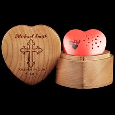 a heart shaped wooden box with two hearts in it and the words, michael smith forever in our hearts