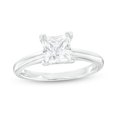 a princess cut diamond ring on a white background