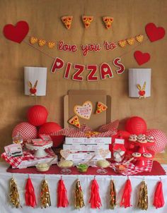 a pizza themed birthday party with red and gold decorations, paper heart garlands and tassels