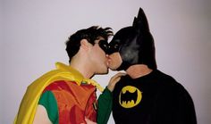 two men dressed as batman kissing each other