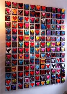 a wall with many different colored hearts on it