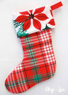 a plaid christmas stocking with a poinsetti on it