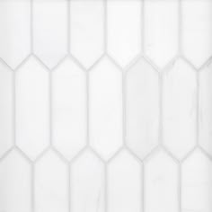 a white tile wall with hexagonal shapes