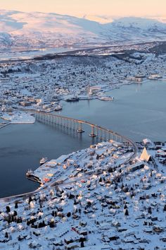 an aerial view of a city with snow on the ground