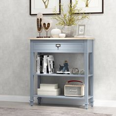 a blue book shelf with two pictures on the wall