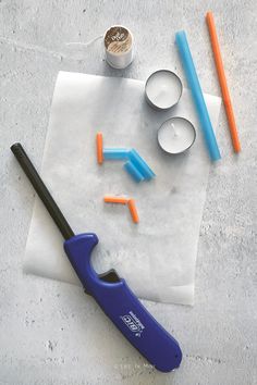 the tools needed to make an ice cream sundae are laid out on a piece of parchment paper