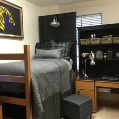 a bed room with a neatly made bed next to a book shelf and a chair