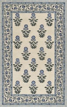 a blue and white rug with flowers on it