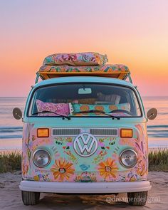 a vw bus parked on the beach at sunset