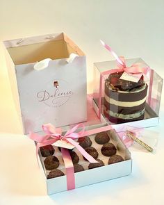 two boxes filled with different types of cakes