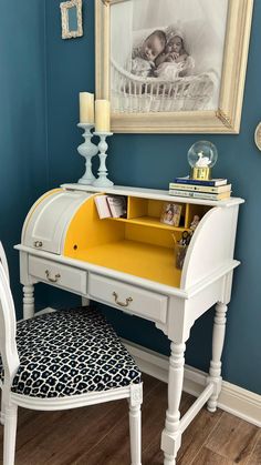 a white desk with yellow drawers and a blue wall