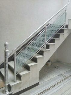 the stairs are made of glass and have metal handrails