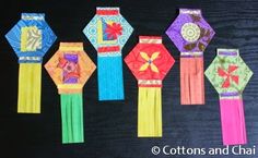 five colorful paper clocks are lined up in a row