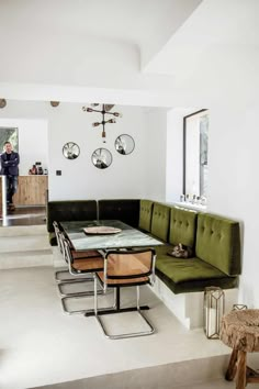 a living room filled with furniture and a dining table