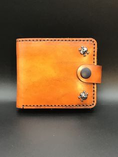 an orange leather wallet sitting on top of a table