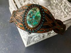 Hand tooled leather cuff bracelet with chrysocolla cabochon | Etsy Wolf Paw Print, Leather Gifts For Her, Leather Cuff Bracelet, Hand Tooled Leather, Leather Cuffs Bracelet, Leather Gifts, Themed Jewelry, Beach Themed, Tooled Leather