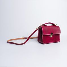 "Product Description * Material: vegetable tanned leather * Color: Hand-dyeing Wine Red * Flap over entry with buckle closure ,a rounded projection on the, please press it down to open the flap * One interior divider * 0.75\" wide leather shoulder strap adjust from 36.61\" to 44.88\" * Sewn by hand; * Size: 150mm (H) x 200mm (W) x 90mm (D) / 5.9\" x 7.8\" x 3.5\" Please first look at the production process of our product. 1. The vegetable tanned leather is made in Italy: Vegetable tanning is an Vegetable Leather, Leather Sling Bag, Logo Gifts, Doctor Bag, Printed Bags, Vegetable Tanned Leather, Wine Red, Sling Bag, Meaningful Gifts