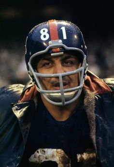 a close up of a football player wearing a helmet with numbers on the sidelines