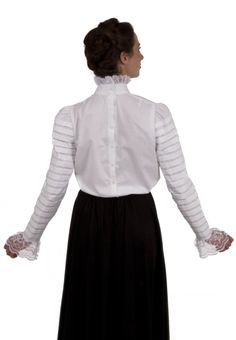 The lavish and luxurious style of the Edwardian Era is clearly seen in this fabulous Edwardian styled blouse! This beautiful cotton blouse has a lacy jabot cascading from the classic high collar and would be a style you would see on Downton Abbey. The long sleeves are detailed with pleating from shoulder to wrist. Hand wash or machine wash gently. Tumble dry low or hang dry. 100% cotton. Poly lace. The model is wearing a skirt and brooch which are both priced separately. Recollections clothing i Cotton Victorian Dress For Formal Occasions, Elegant Victorian Cotton Dress For Formal Occasions, Classic Fitted Ruffle Blouse, Classic Fitted Blouse With Ruffles, Classic Fall Blouse With Lace Cuffs, Victorian Fitted Ruffled Blouse, Victorian Fitted Ruffle Blouse, Elegant Victorian Cotton Dress With Ruffles, Victorian Style Formal Tops With Ruffles