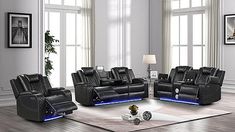 a living room filled with black leather couches and recliners on top of a hard wood floor