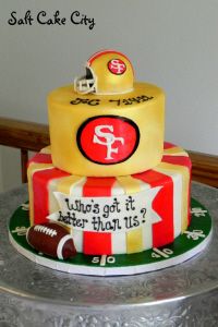 a three tiered cake decorated with footballs and other sports related items on it