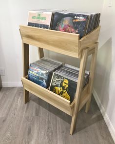 a wooden shelf with several records on it