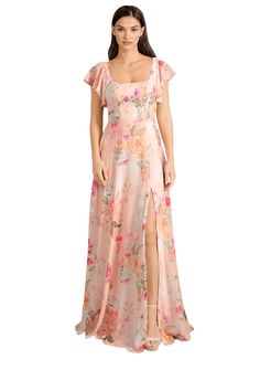 a woman wearing a long dress with flowers on it and a slit down the side