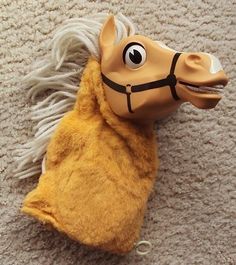 a stuffed horse head laying on top of a carpet