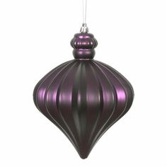 a purple ornament hanging on a white background