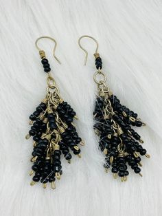 Ethnic earrings - beaded in black beads Nepal Tibet, Kochi, Afghan silver coral stone earring Your order will be sent in a box or gift bag The Kouchis are a nomadic people who are among the Pashtun tribes. They live in the Hindu Kush mountains, between Afghanistan and Pakistan. They take care of their herds of livestock in their daily life. These are jewelry worn by nomads for a long time. Each piece is original, with its little rough edges that give it its charm. Bohemian Black Dangle Jewelry, Black Bohemian Dangle Jewelry, Nickel-free Black Plug Earrings As Gift, Traditional Black Beaded Earrings, Nickel-free Black Dangle Jewelry, Nickel Free Black Plug Earrings For Festival, Nickel-free Black Plug Earrings For Festival, Black Nickel-free Dangle Jewelry, Traditional Tassel Earrings With Dangling Beads As Gift