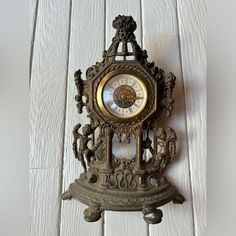 an antique clock is hanging on the wall