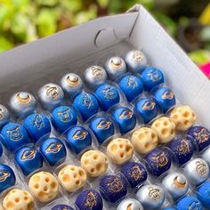 a box filled with lots of different colored beads