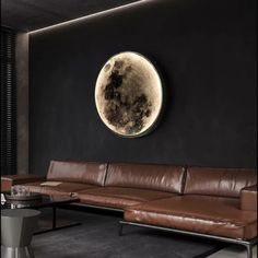 a living room filled with furniture and a large moon on the wall