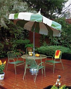 an umbrella and chairs on a wooden deck