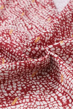 a red and white fabric with an abstract design