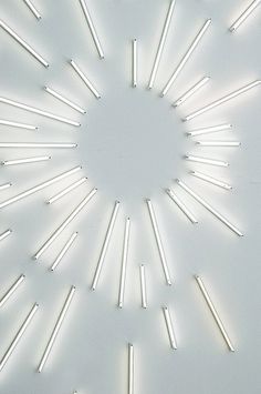 an abstract white background with lots of sticks arranged in the shape of a starburst