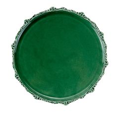 a green plate with an ornate design on the rim and sides, isolated against a white background