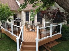 a deck with chairs and an umbrella on it