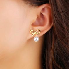 Introducing our Bow Pearl Earrings, a must-have accessory for any fashion-forward individual. With a super cute bow design and luxurious pearls, these earrings add a touch of girly charm to any outfit. Embrace the latest trend with these exclusive earrings. Made to last! Non Tarnish and Water Resistant, Hypoallergenic .78" Long 18K Gold Plated over 316L Stainless Steel base Trendy Bow Drop Earrings, Pearl Jewelry With Bow Detail, Trendy Pearl Charm Earrings For Party, Trendy Pearl Charm Earrings For Gift, Trendy Pearl Earrings With Pearl Charm For Party, Trendy Party Pearl Earrings With Charm, Cute Pearl Drop Earrings For Gift, Cute Pearl Drop Earrings As Gift, Exclusive Earrings