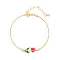 a gold bracelet with two pink roses on the front and green leaves on the back