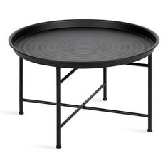 a black tray with metal legs and a circular design on the top, sitting on a white background