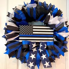 a patriotic wreath with an american flag and stars on the front, hanging on a door